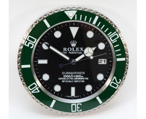 A 'Rolex' style advertising wall clock, green surround with black dial reads 'Submariner' having quartz movement, 34cm diamet