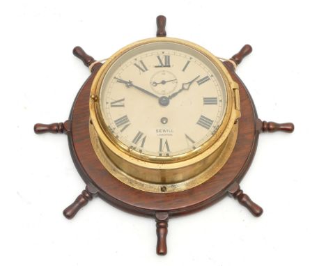 A Sewill Liverpool brass bulkhead clock, with an eight day mechanical movement, dial 15cm in diameter, mounted on a wooden sh