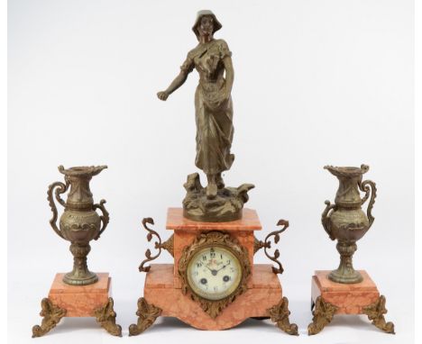 An early 20th century French spelter and rouge marble clock garniture, the enamel dial showing Arabic numerals, having an eig