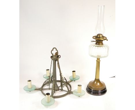 A cast-iron electric ceiling light fitting, Gothic in style with five branches, together with a Victorian twin wick oil lamp,