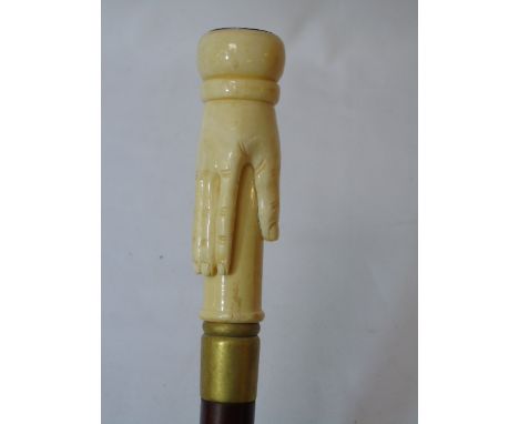 Carved bone walking stick in the form of a hand with a compass top approx 39" long