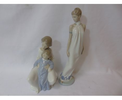 Nao figure of a mother with child seated  approx 8" and a Nao figure of lady approx 12" tall