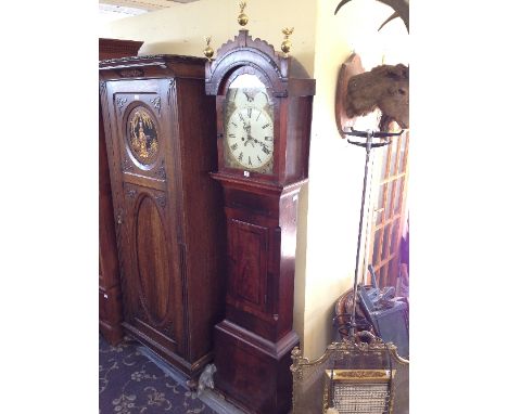 A 19th century mahogany cased longcase clock with white enamel Roman moon faced circular dial.