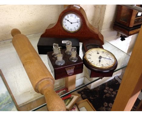 An Edwardian mahogany mantle clock together with a rolling pin and other items.