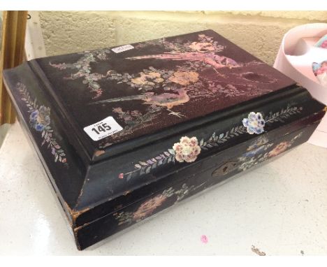 An early 20th century Japanese lacquer dressing table box with mother of pearl inlaid bird and floral decoration and fitted i
