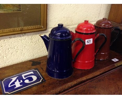 Three multi coloured Polish enamel coffee pots together with a French enamel house number sign: 45.