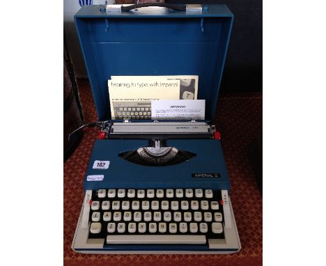 A mid 20th century Imperial 220 portable typewriter with instruction manual (excellent condition).