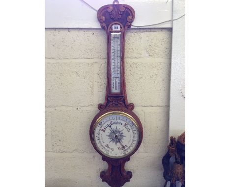 A good quality early 20th century carved oak cased wall barometer.