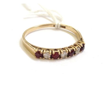 A 9 carat gold ladies' dress ring set red and white stones.
(X59524)