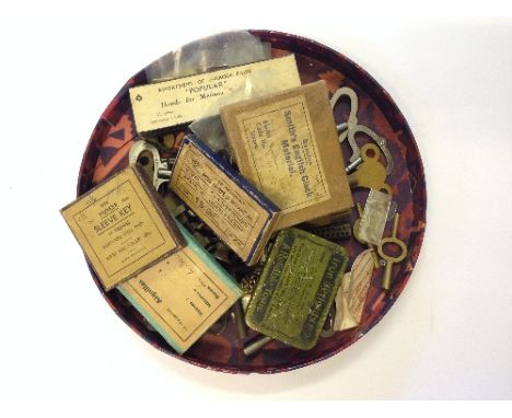 A collection of various clock keys and watch repairing items.