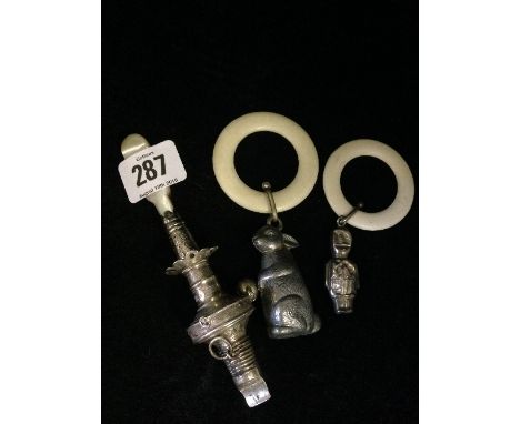 A Victorian babies' silver rattle and whistle with mother of pearl handle (unmarked) together with two others.