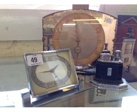 Two Art Deco clocks together with an Art Deco Ronson table lighter.
(R30)