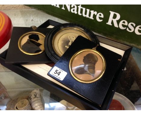 Two framed Victorian silhouettes inscribed with details to reverse together with a Victorian oval photographic portrait and a