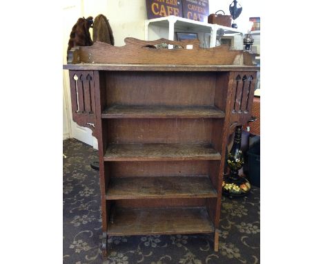 An Arts & Crafts Liberty & Co. style oak four shelf bookcase.