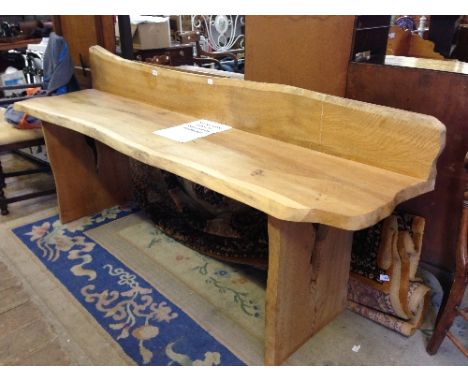 A large oak wooden bench