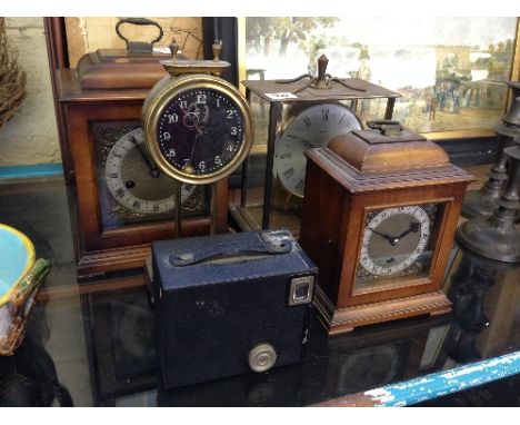 Four various mantle clocks together with a Brownie Target Six-Twenty box camera.