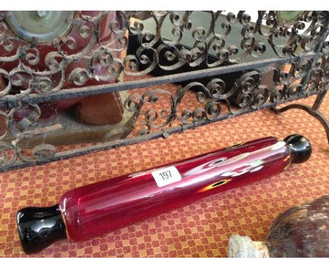 A ruby glass Murano style rolling pin.