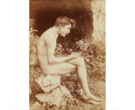 Gloeden, Wilhelm von Portrait of a man in profile facing right, sitting on a rock circa 1900, albumen print mounted on album 