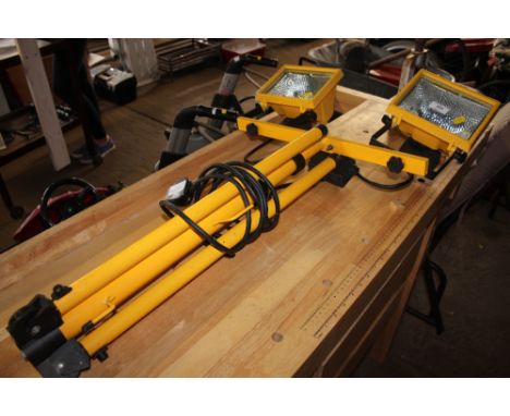 A twin halogen flood light on a tripod stand