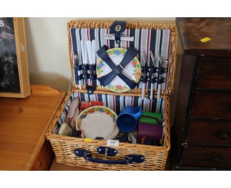 A wicker picnic hamper and contents 