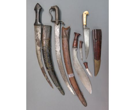 ˜AN INDIAN DAGGER (KARD) AND THREE FURTHER DAGGERS, 19TH AND 20TH CENTURY the first with tapering single-edged blade and a pa