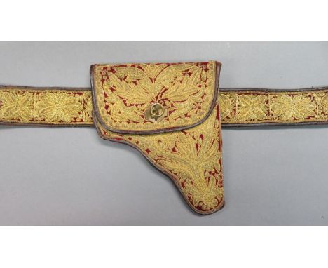 AN OTTOMAN DECORATED HOLSTER, TURKEY, LATE 19TH/20TH CENTURY the interior lined in green velvet, the exterior of red velvet e