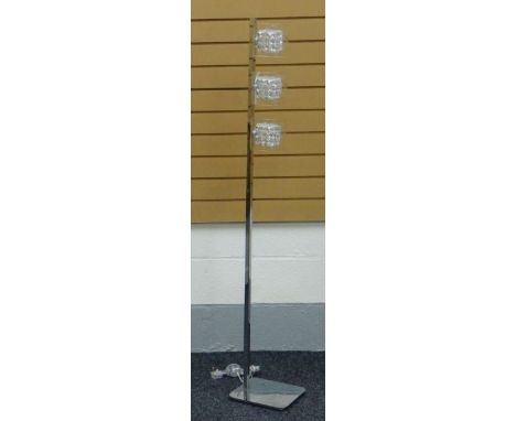 A MODERN CHROME STANDARD LAMP having a platform base and three cubic bulbs and shades