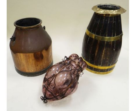 A PURPLE GLASS HANGING LANTERN in a metallic scroll-work frame, together with a cooper-work umbrella stand and a copper churn