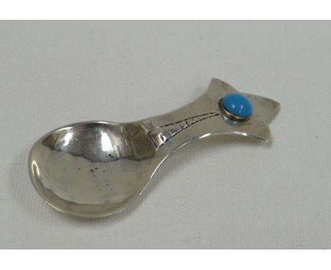 AN ARTS &amp; CRAFTS SILVER CADDY SPOON BY ALBERT EDWARD BONNER with floral splayed terminal and turquoise jewel, London, 0.3