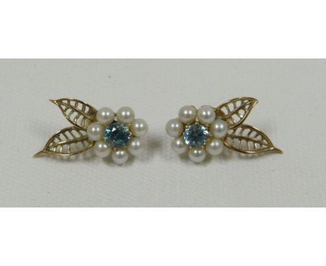 A PAIR OF PEARL & BLUE STONE EARRINGS of a floral arrangement with two openwork gold leaves in 9ct yellow gold