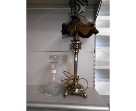 A white metal lamp and a ships decanter 