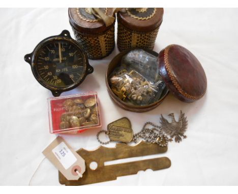 A selection of military items to include tags, cap badge, button stick, cigarette tins with applied decoration etc