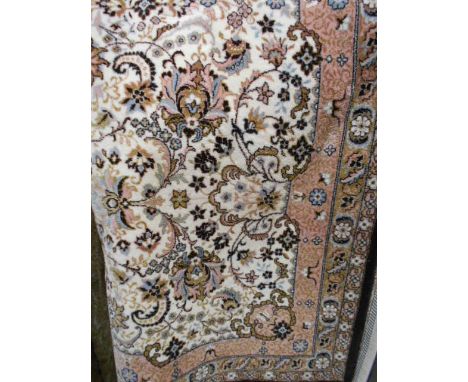 A Super Tabriz fawn ground rug with stylized pattern 