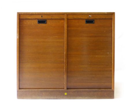 A 1940/50's Danish oak twin tambour door cabinet on a plinth base, w. 88 cm   CONDITION REPORT:  One key, structurally sound,