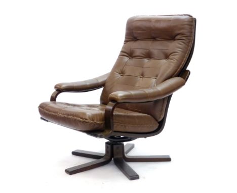 A brown button upholstered swivel lounge chair on a bentwood five star base