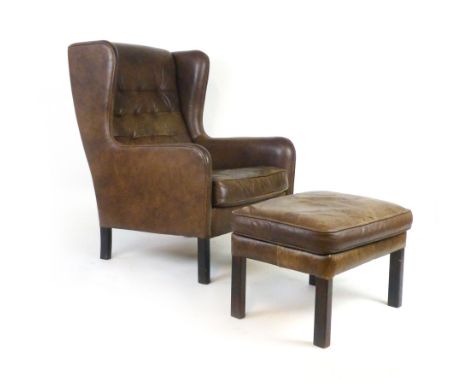 A 1970's brown button upholstered lounge wingback armchair together with a matching footstool