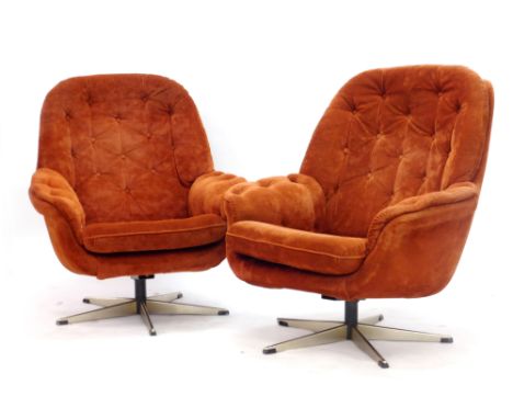 A pair of red button draylon swivel lounge chairs, each on a five star base