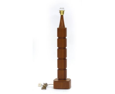 A 1970's teak lamp base of undulating form, h. 77 cm   CONDITION REPORT:  Working order unknown, may require rewiring