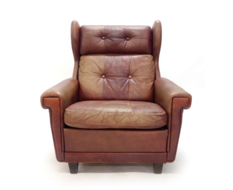 A Skippers Mobler brown leather button upholstered wing armchair   CONDITION REPORT:  Heavy wear