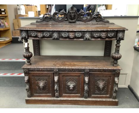 A late 19th century Flemish carved oak buffet, width 150cm, depth 55cm, height 155cm. Condition - fair
