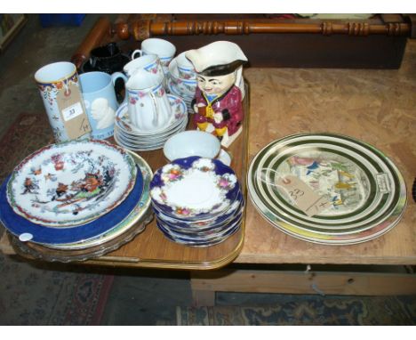 A Tray of decorative ceramics including a French cylindrical vase decorated in shades of blue and yellow with a coat of arms 