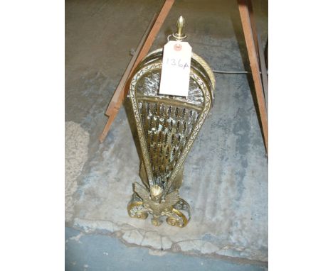 A Pierced brass folding fan style firescreen.