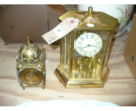 A Smiths brass cased lantern clock and a Kundo torsion clock on a hexagonal base. (2)