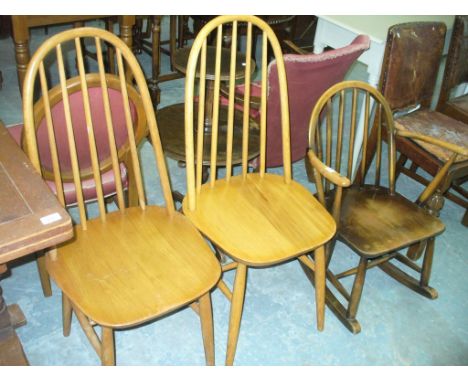 An Ercol rocking chair and a pair of light elm Ercol hoop back kitchen chairs. (3)