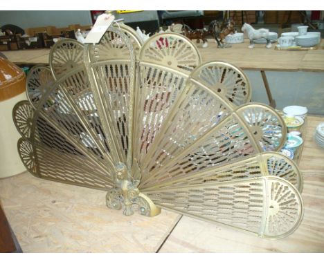 A Folding pierced brass fan fireguard.