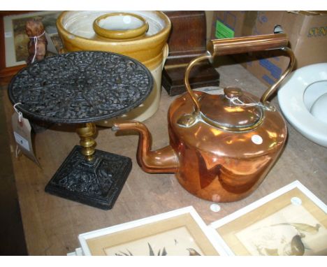 A Victorian copper kettle with a button finial and a painted iron openwork trivet. (2)