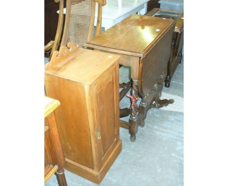 A 1930's Oak barley twist drop leaf table and a Victorian satinwood pot cupboard with a single panelled door.