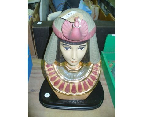 A Ceramic bust of an Egyptian on a hardwood plinth.