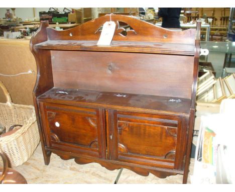 A Victorian walnut hanging wall cabinet with a single shelf above two panelled cupboard doors.