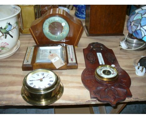 An Early 20th century carved oak Black forest style wall barometer , the pediment carved with crossed shot guns and a hunting